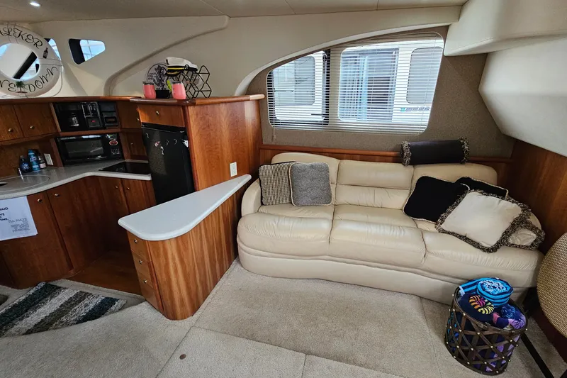 Slide: The Image of Interior of 2003 Silverton 35 Motor Yacht with cozy seating and modern kitchen amenities. - 18