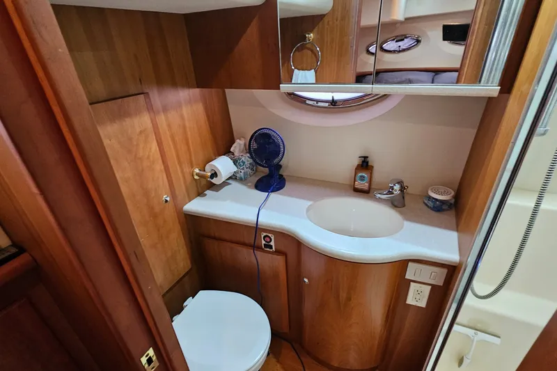 Slide: The Image of Bathroom interior of 2003 Silverton 35 Motor Yacht with wooden cabinetry and modern fixtures. - 30