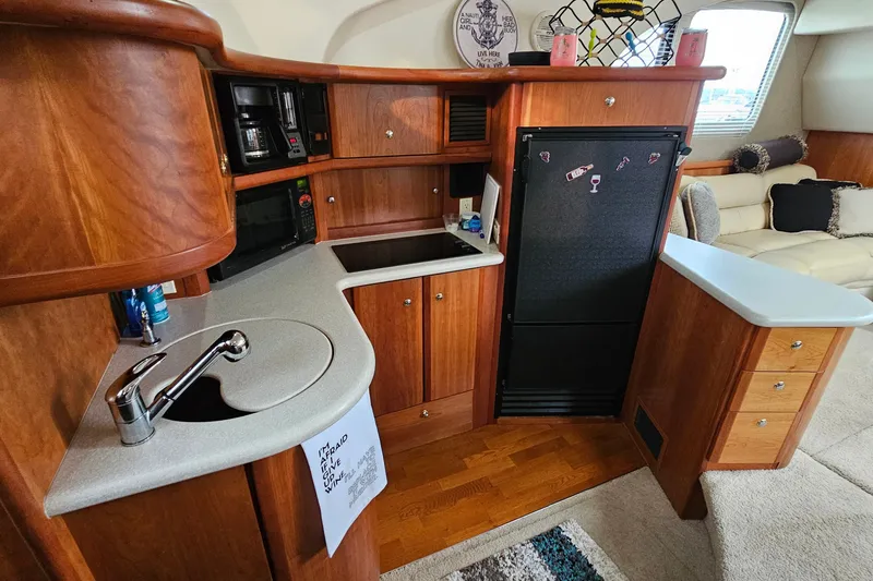 Slide: The Image of 2003 Silverton 35 Motor Yacht kitchen with wood cabinetry and modern appliances. - 21
