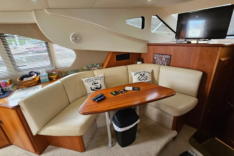Slide: The Image of Interior of 2003 Silverton 35 Motor Yacht with cozy seating and wooden table. - 20