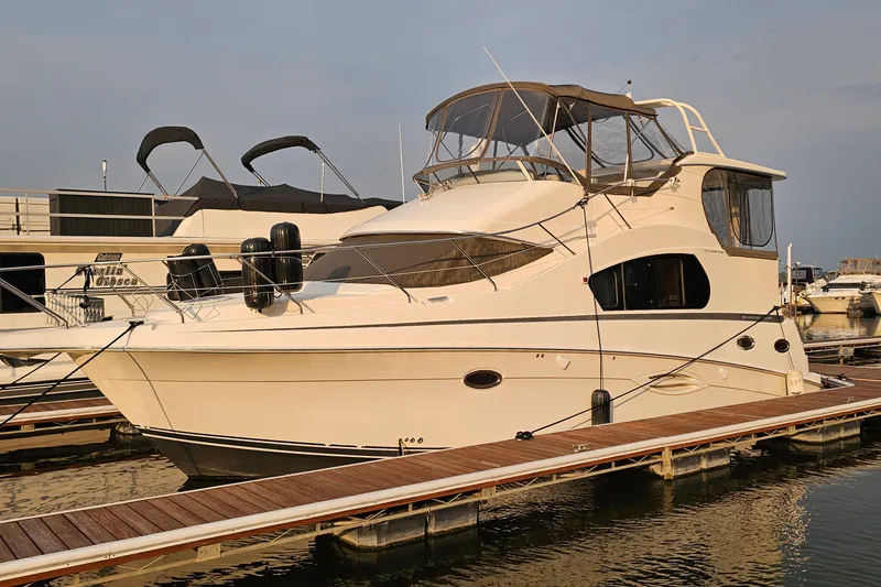 Slide: The Image of 2003 Silverton 35 Motor Yacht docked at marina, showcasing sleek design and spacious cabin. - 2
