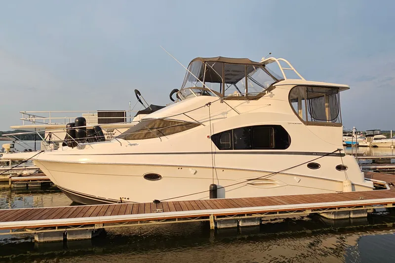 The Image of 2003 Silverton 35 Motor Yacht docked at marina under clear sky. - 1