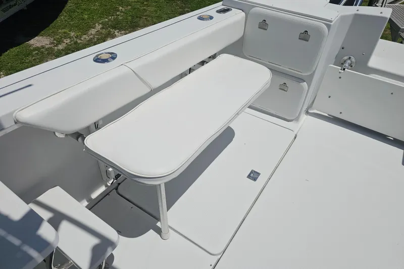 Slide: The Image of 2007 Glacier Bay 2670 Isle Runner boat interior with white seating and storage compartments. - 17