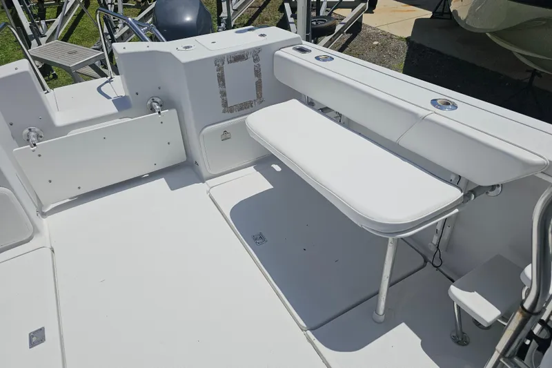 Slide: The Image of 2007 Glacier Bay 2670 Isle Runner boat interior with white seating and storage compartments. - 16