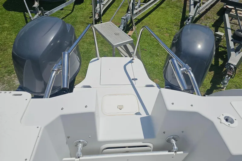 Slide: The Image of 2007 Glacier Bay 2670 Isle Runner boat with dual outboard motors on a trailer. - 18