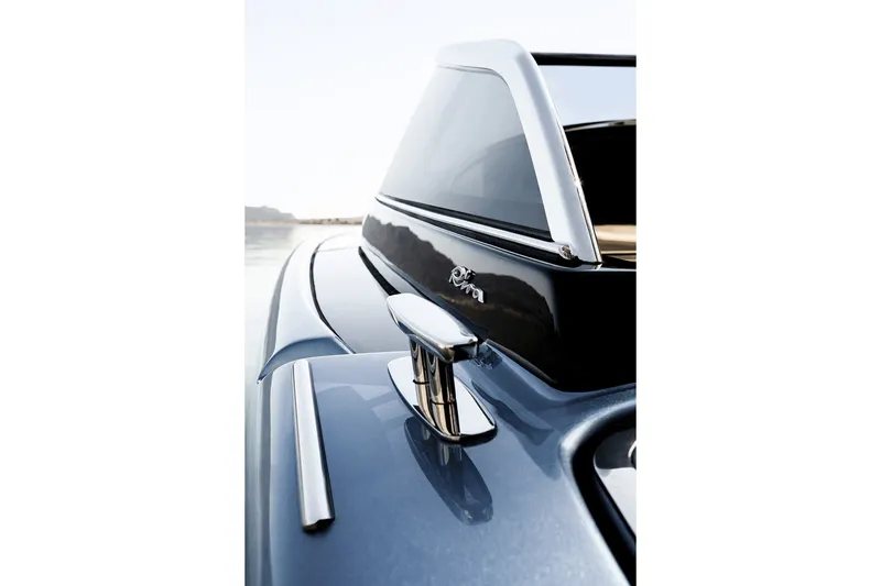Slide: The Image of Close-up of 2004 Riva El-Iseo boat, showcasing sleek design and chrome details. - 11