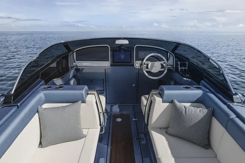 Slide: The Image of Luxurious 2004 Riva El-Iseo boat interior with elegant seating and modern dashboard on open water. - 14