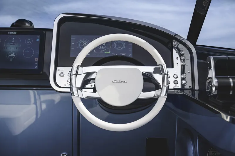 Slide: The Image of Steering wheel and dashboard of a 2004 Riva El-Iseo boat, featuring modern controls and displays. - 15