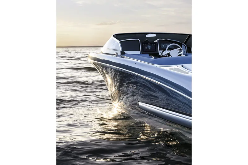 Slide: The Image of Sleek 2004 Riva El-Iseo boat cruising on calm waters at sunset. - 8