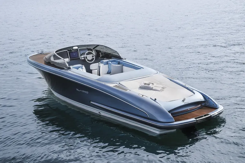 Slide: The Image of Luxury 2004 Riva El-Iseo boat on calm water, showcasing sleek design and elegance. - 5