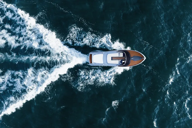 Slide: The Image of Aerial view of 2004 Riva El-Iseo boat cruising through ocean waves. - 7