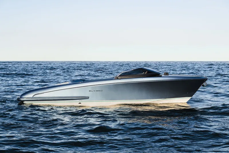 Slide: The Image of Sleek 2004 Riva El-Iseo boat cruising on open sea under clear sky. - 9