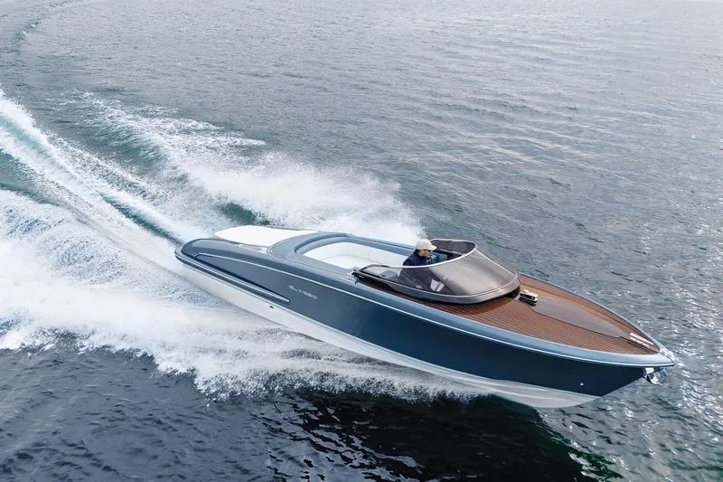 Slide: The Image of Luxurious 2004 Riva El-Iseo speedboat cruising swiftly on open water. - 6