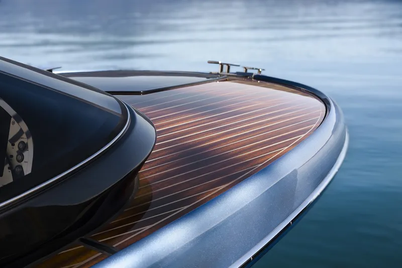 Slide: The Image of Close-up of 2004 Riva El-Iseo yacht's sleek wooden deck on calm water. - 10