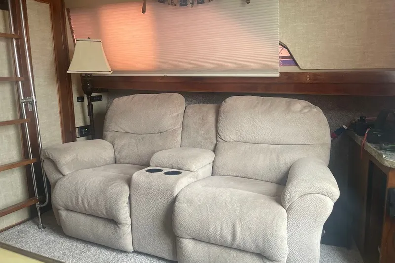 Slide: The Image of Cozy beige recliner sofa inside a 1980 Carver 33 Mariner boat cabin. - 9