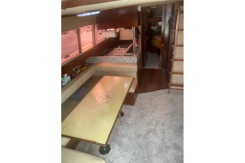 Slide: The Image of Interior of 1980 Carver 33 Mariner yacht with dining area and kitchen. - 5