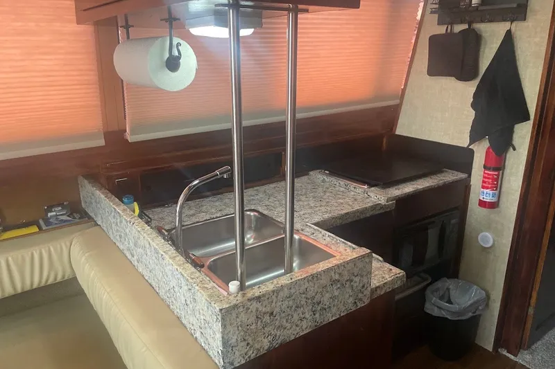 Slide: The Image of Interior of 1980 Carver 33 Mariner yacht kitchen with granite countertops and sink. - 6
