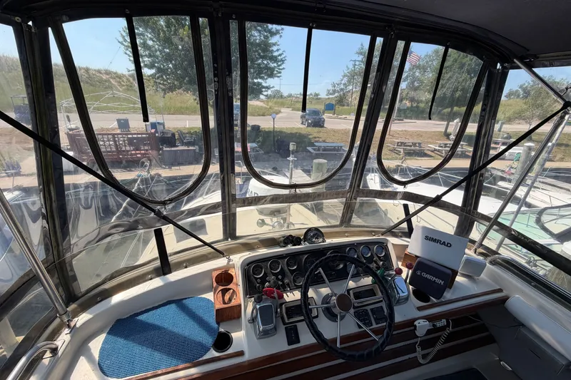 Slide: The Image of 1987 Silverton 34 Convertible boat cockpit with steering wheel and navigation equipment. - 10