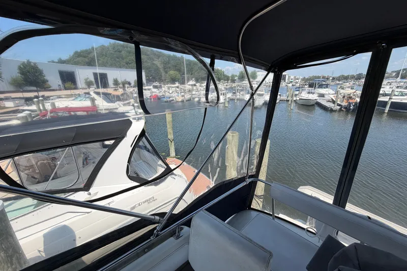 Slide: The Image of 1987 Silverton 34 Convertible yacht docked at a marina, surrounded by other boats. - 14