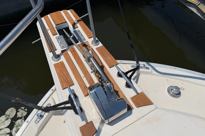 Slide: The Image of Bow of 1987 Silverton 34 Convertible with anchor and wooden accents. - 38