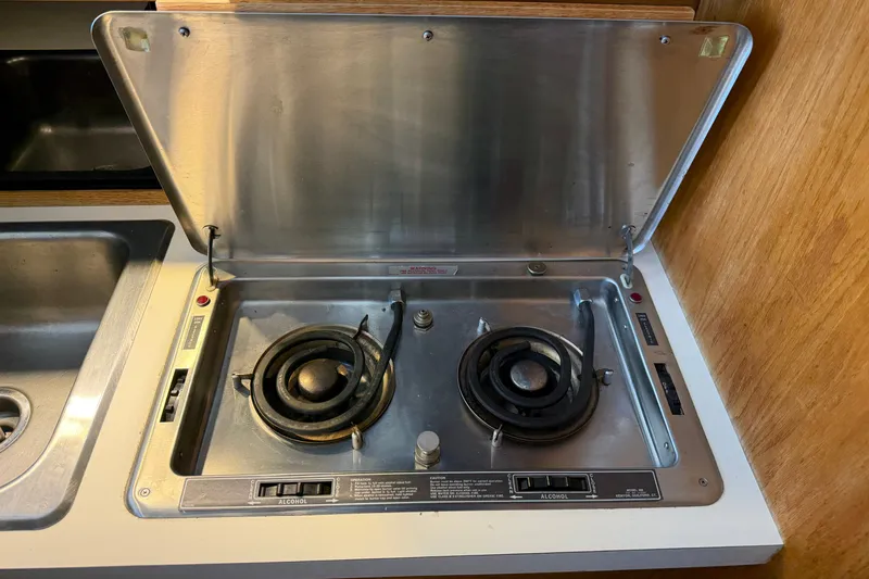 Slide: The Image of 1987 Silverton 34 Convertible boat stove with two burners and stainless steel cover. - 29
