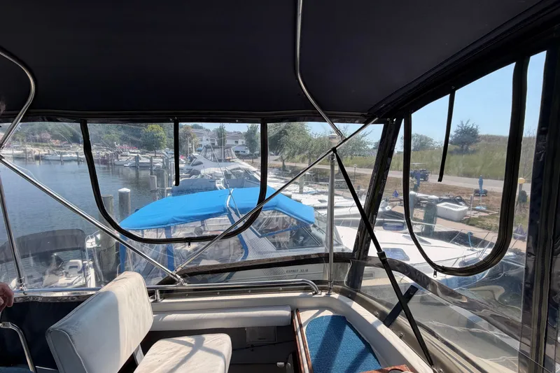 Slide: The Image of Interior view of 1987 Silverton 34 Convertible boat docked at marina. - 13