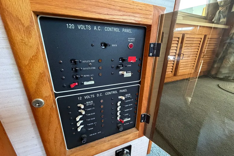 Slide: The Image of Electrical control panel on a 1987 Silverton 34 Convertible boat, featuring AC and DC switches. - 36