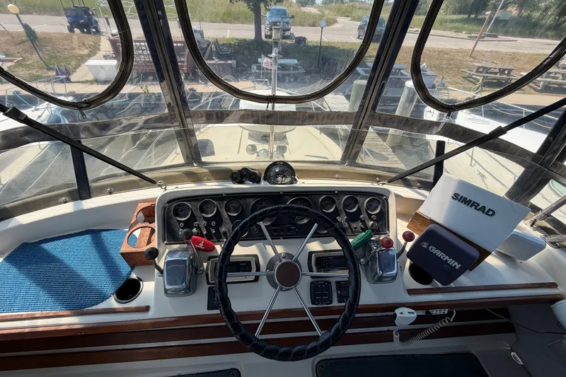 Slide: The Image of 1987 Silverton 34 Convertible boat cockpit with steering wheel, gauges, and navigation equipment. - 11