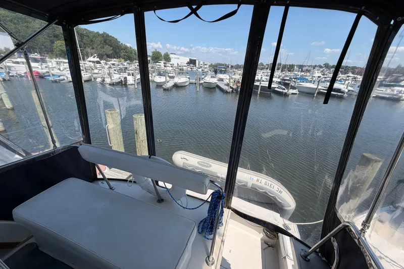 Slide: The Image of 1987 Silverton 34 Convertible yacht interior view overlooking marina with numerous docked boats. - 15