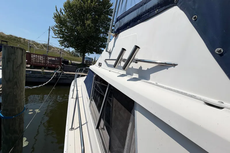 Slide: The Image of 1987 Silverton 34 Convertible yacht docked at marina, side view with clear sky. - 5