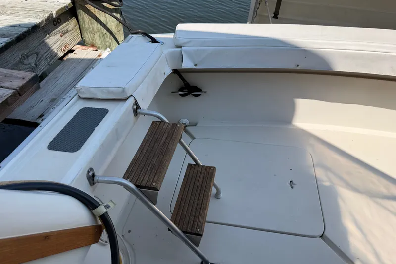 Slide: The Image of 1987 Silverton 34 Convertible boat deck with wooden steps and seating area. - 9