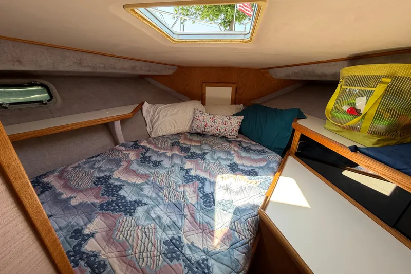 Slide: The Image of Cozy cabin interior of 1987 Silverton 34 Convertible boat with bed and skylight. - 30
