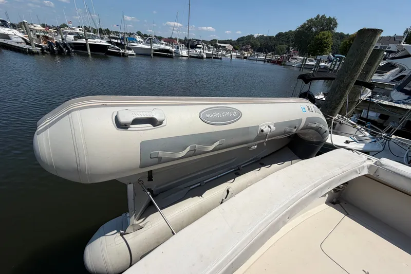 Slide: The Image of Inflatable dinghy on 1987 Silverton 34 Convertible yacht, docked at marina. - 39