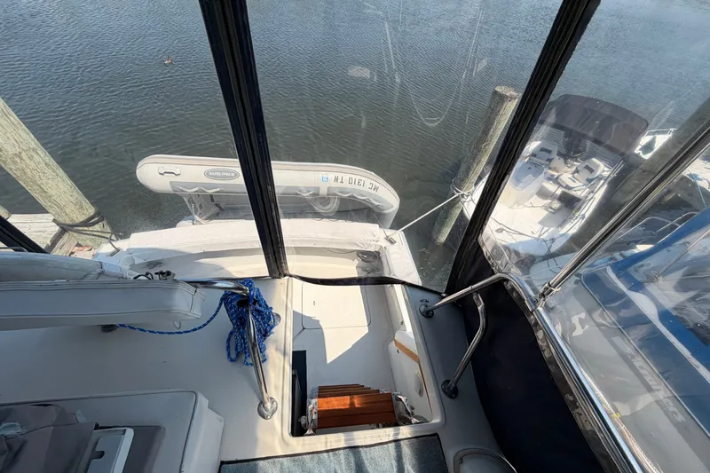 Slide: The Image of 1987 Silverton 34 Convertible boat interior with docked inflatable dinghy. - 16