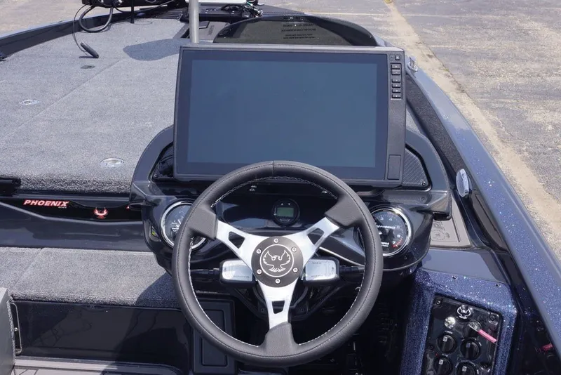 Slide: The Image of Dashboard of a 2027 Phoenix 921 Elite X boat with steering wheel and large display screen. - 20
