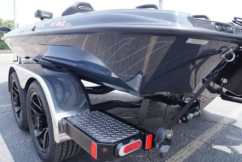 Slide: The Image of 2027 Phoenix 921 Elite X boat on trailer, showcasing sleek design and dual wheels. - 24