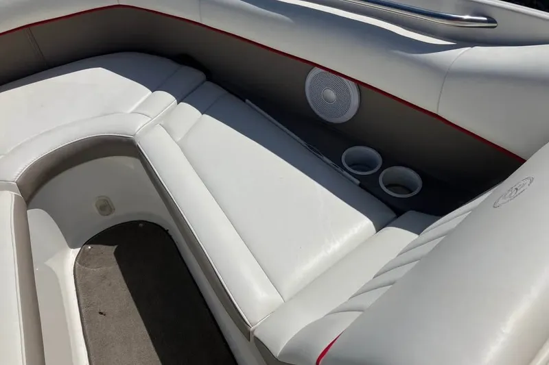 Slide: The Image of Interior seating of a 2003 Cobalt 220 boat with cup holders and speaker. - 10