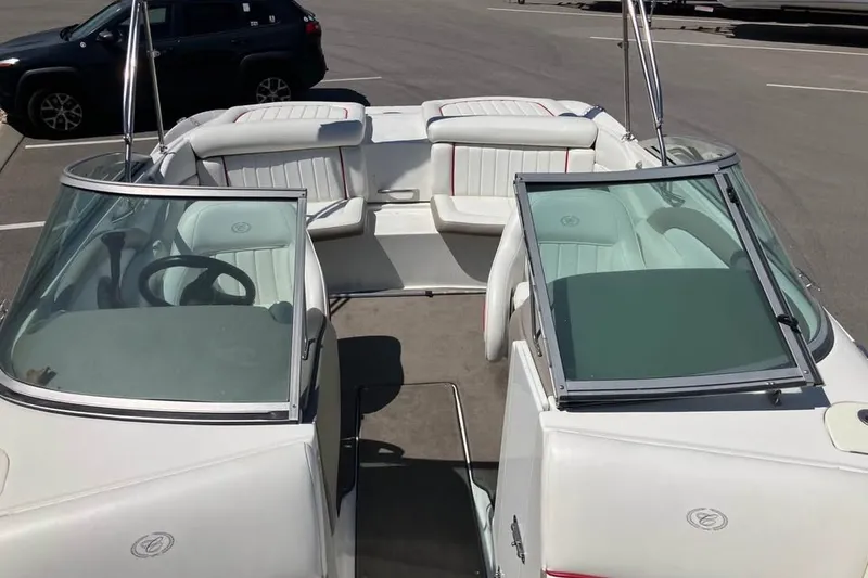 Slide: The Image of 2003 Cobalt 220 boat interior with white seating and dual windshields. - 7