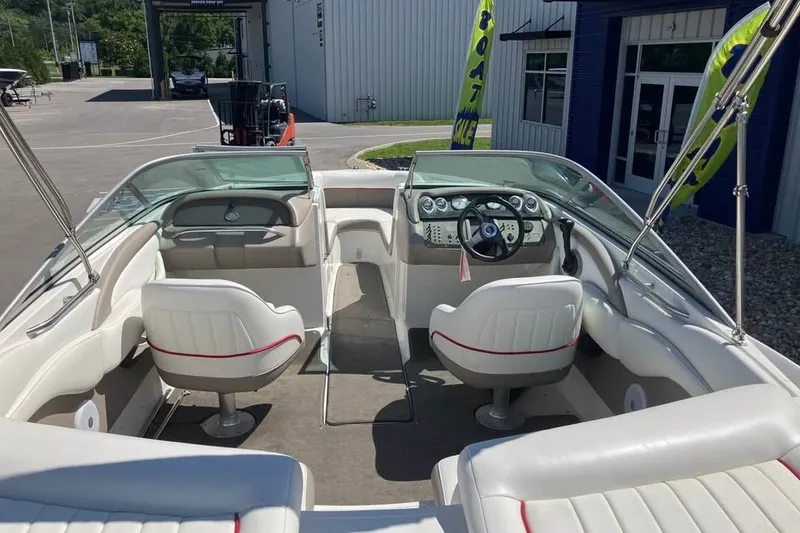 Slide: The Image of Interior of a 2003 Cobalt 220 boat with white seating and dashboard. - 11