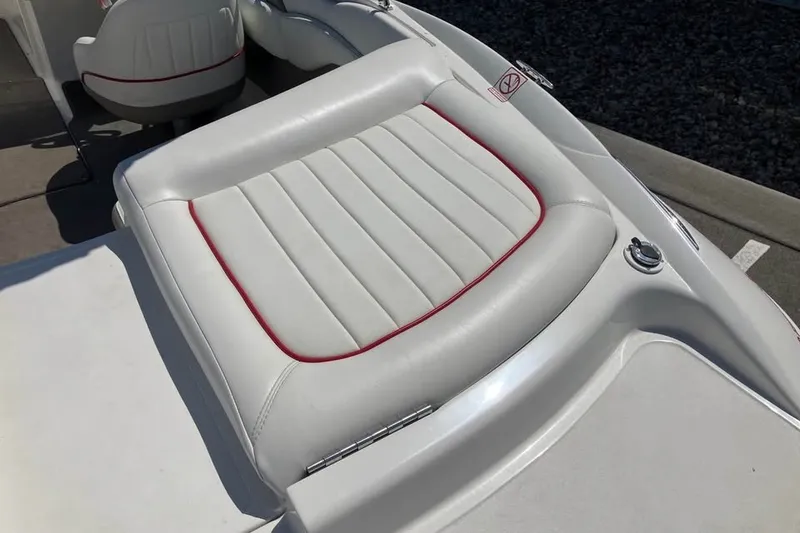 Slide: The Image of White leather boat seat with red trim on a 2003 Cobalt 220. - 13