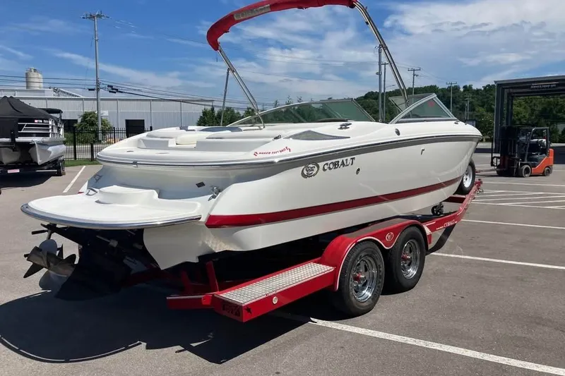 Slide: The Image of 2003 Cobalt 220 boat on red trailer in parking lot, sunny day. - 5