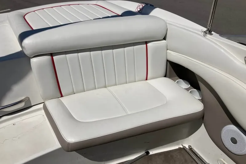 Slide: The Image of White leather seating on a 2003 Cobalt 220 boat with red accents. - 17