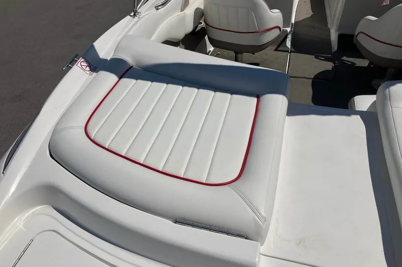Slide: The Image of 2003 Cobalt 220 boat interior with white and red-trimmed seating. - 12