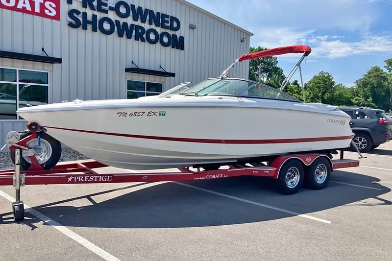 The Image of 2003 Cobalt 220 boat on trailer outside pre-owned showroom. - 1