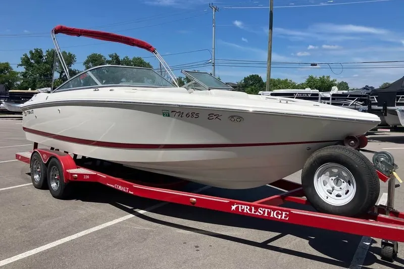 Slide: The Image of 2003 Cobalt 220 boat on red Prestige trailer in parking lot. - 4