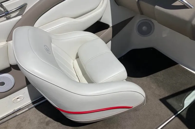 Slide: The Image of White leather boat seat in a 2003 Cobalt 220, featuring sleek design and speaker detail. - 15