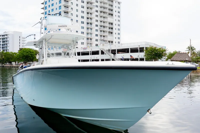 The Image of 2019 SeaVee 390Z boat docked near modern buildings, showcasing sleek design and advanced features. - 1