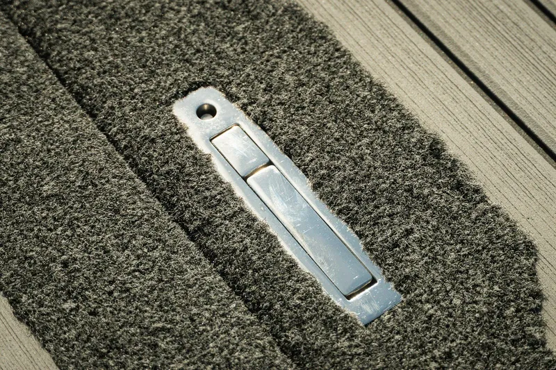 Slide: The Image of Close-up of Bass Cat Lynx STS 2026 boat carpet with metal latch detail. - 18
