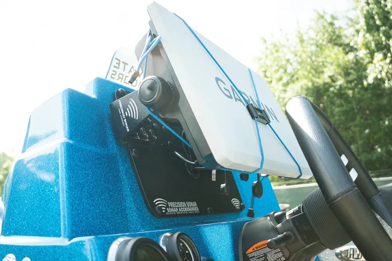 Slide: The Image of 2026 Bass Cat Lynx STS boat dashboard with Garmin sonar system and steering wheel. - 19