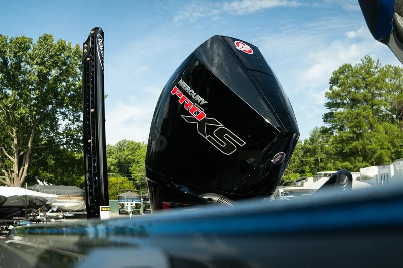 Slide: The Image of 2026 Bass Cat Lynx STS with Mercury Pro XS engine, outdoors under clear sky. - 22